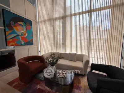 Stylish modern living room with large windows and contemporary art