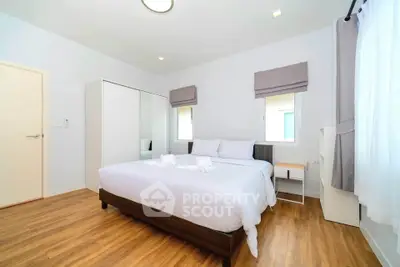 Spacious bedroom with modern decor and natural light
