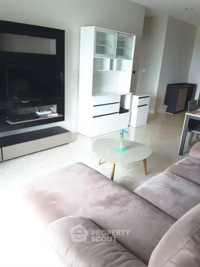 Modern living room with sleek furniture and neutral tones, perfect for relaxation and entertainment.