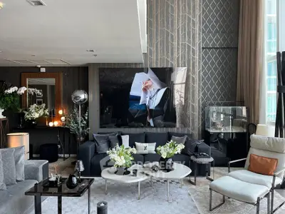 Luxurious modern living room with elegant decor and large windows