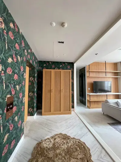 Stylish living room with floral wallpaper and modern furniture in a chic apartment.