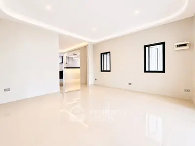 Spacious modern living room with sleek tile flooring and recessed lighting