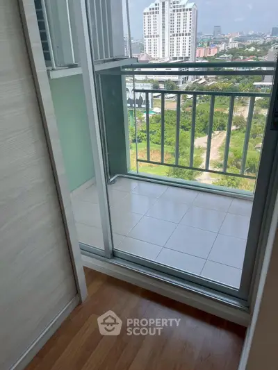 Charming small balcony with city view, perfect for relaxation and enjoying the urban landscape.