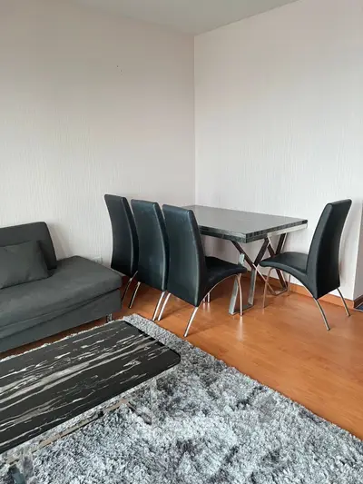 Modern living room with sleek furniture and stylish dining area