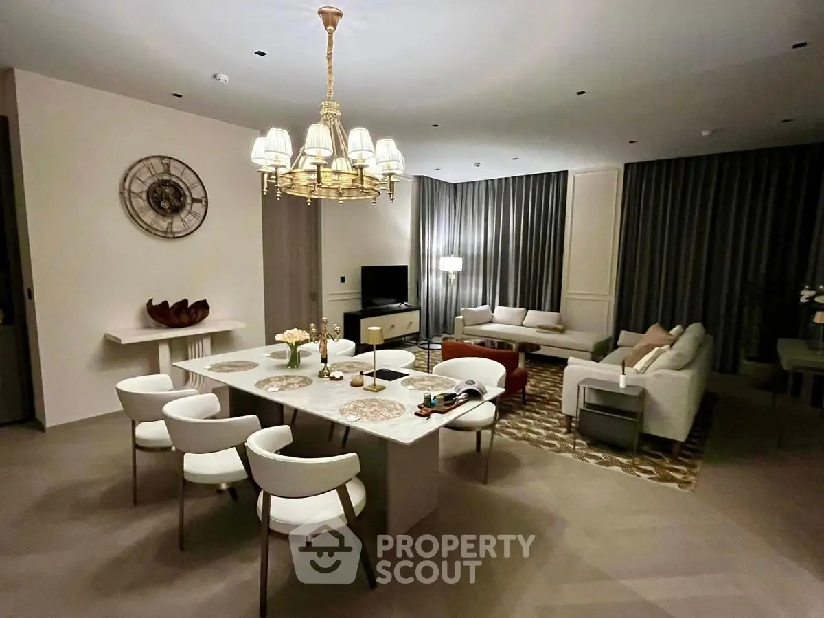 Luxurious living room with elegant chandelier and modern furniture, perfect for entertaining guests.