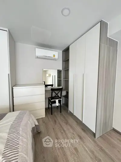 Modern bedroom with sleek wardrobe and stylish flooring