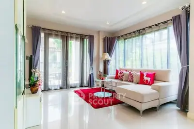 Spacious and bright living room with modern decor and large windows.