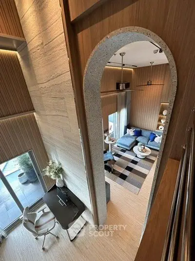 Modern loft-style living room with high ceilings and stylish decor