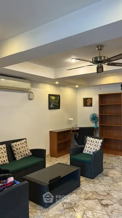 Spacious living room with modern furniture and ceiling fan