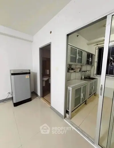 Modern kitchen with closed layout and sleek cabinetry in a contemporary apartment.