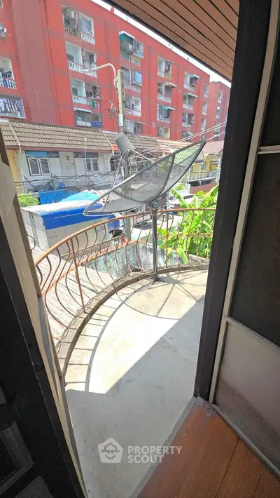 Charming balcony with unique railing and city view, perfect for relaxation and enjoying urban life.