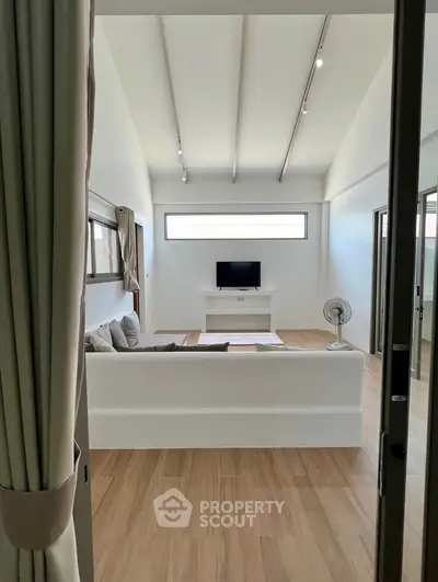 Spacious modern living room with minimalist decor and natural light