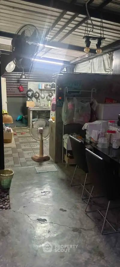 Cozy kitchen with open layout and dining area, featuring modern appliances and industrial-style decor.