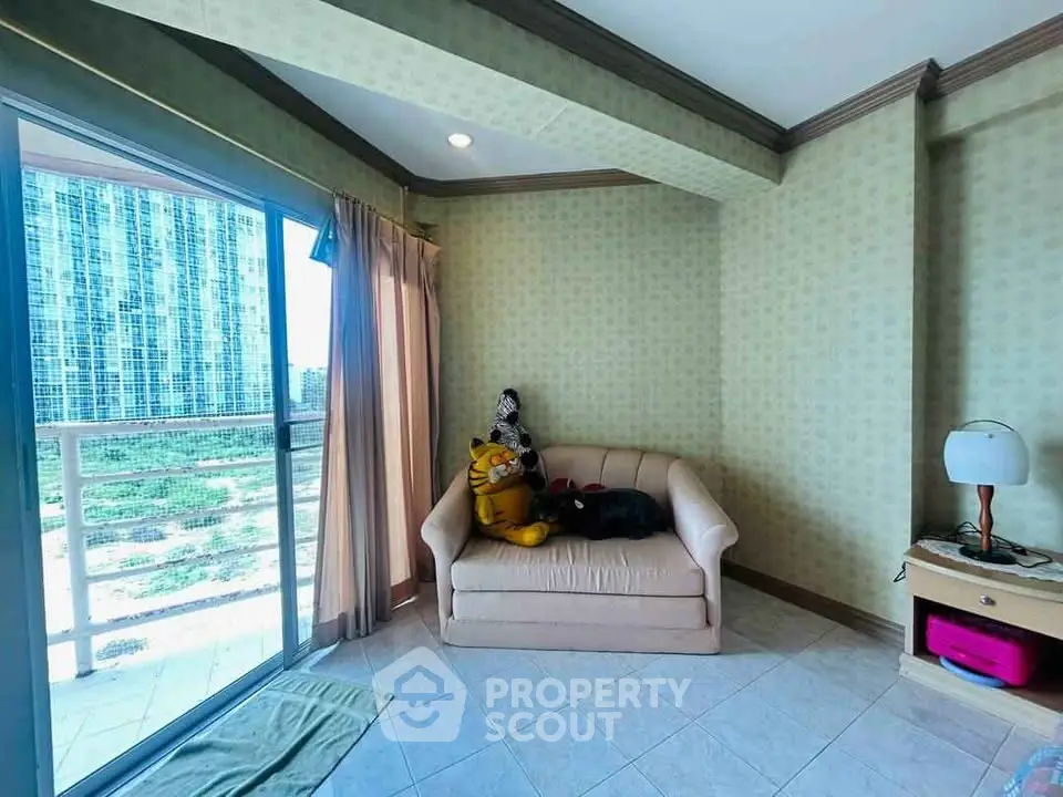 Cozy living room with balcony access and plush sofa in modern apartment