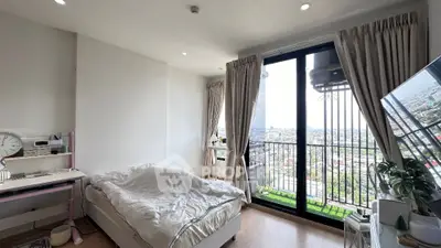 Modern bedroom with balcony offering stunning city view