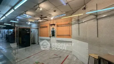 Spacious commercial space with glass entrance and tiled flooring, ideal for retail or office setup.