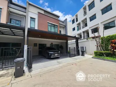 Modern townhouse with carport and contemporary facade in urban setting