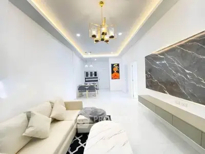 Luxurious modern living room with elegant chandelier and marble accent wall