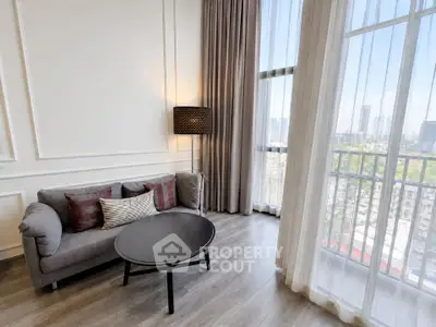 Elegant living room with city view, featuring modern sofa and floor-to-ceiling windows.