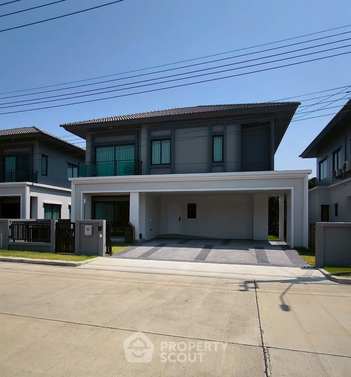 Modern two-story house with spacious driveway and contemporary design in a suburban neighborhood.