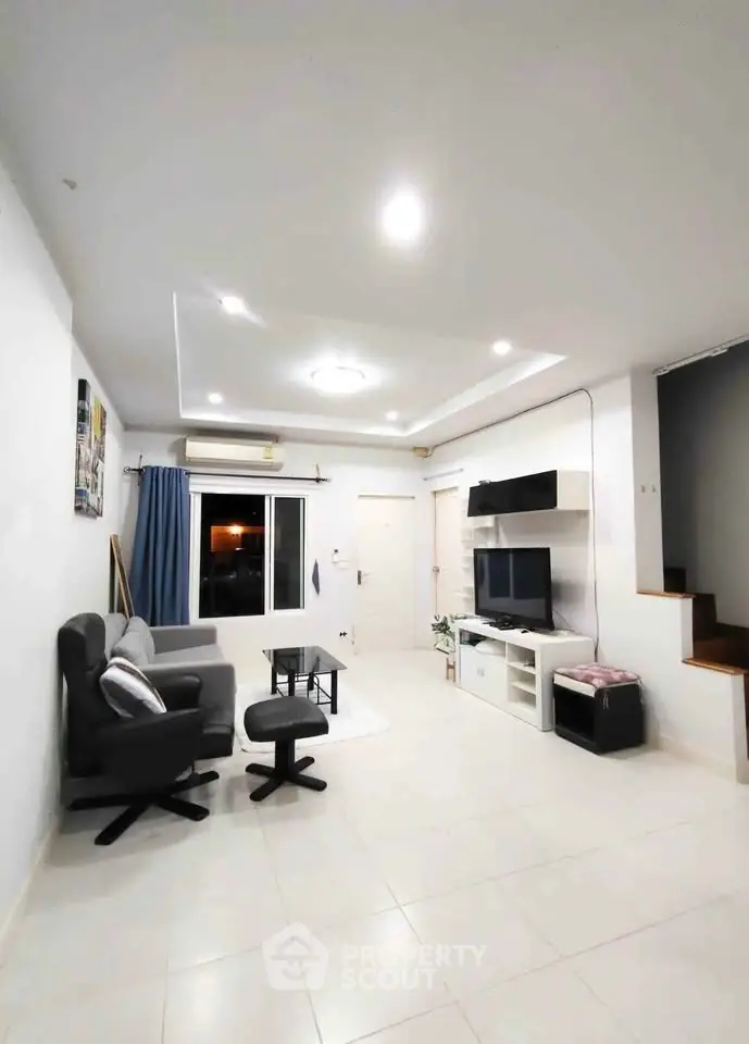 Spacious modern living room with sleek furniture and ambient lighting