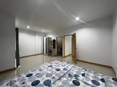 Spacious bedroom with modern decor and ample natural light