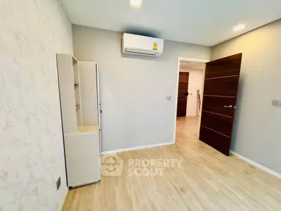 Modern empty room with air conditioning and wooden flooring