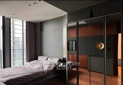 Luxurious modern bedroom with floor-to-ceiling windows and sleek mirrored wardrobe in urban high-rise.
