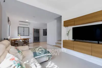 Spacious modern living room with sleek TV unit and cozy seating area