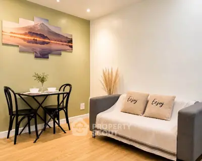Cozy living room with stylish decor and dining area, perfect for relaxation and entertaining.