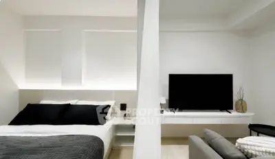 Modern bedroom with sleek design and large TV setup