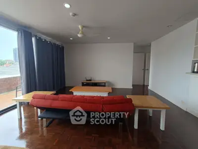 Spacious living room with modern furniture and large windows for natural light.