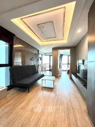 Modern living room with stylish ceiling and wood flooring