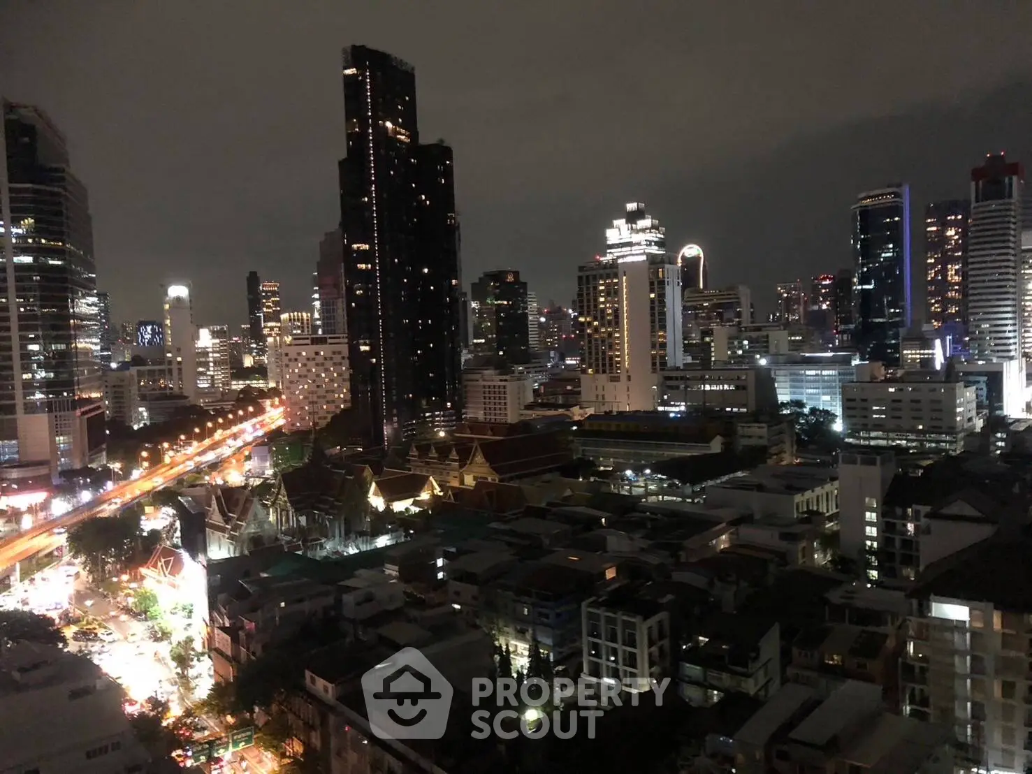 Stunning cityscape view showcasing vibrant urban skyline at night with illuminated skyscrapers.