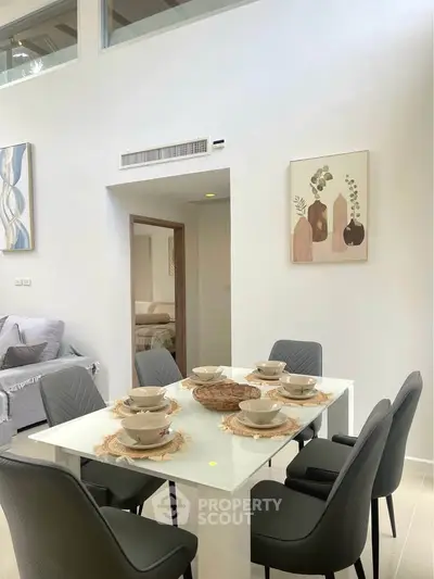 Modern dining area with elegant table setting in a bright, open-concept living space.