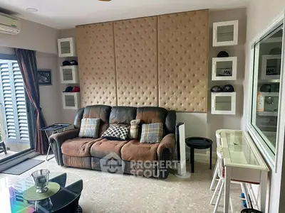 Stylish living room with plush sofa and modern decor, perfect for relaxation and entertainment.