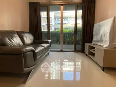 Modern living room with leather sofa and large window view
