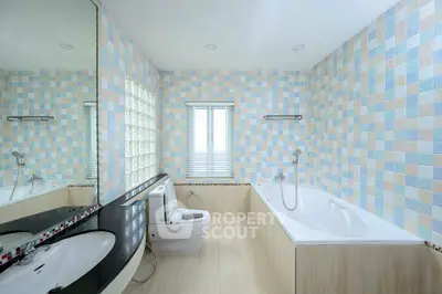 Spacious bathroom with modern bathtub and stylish tile design