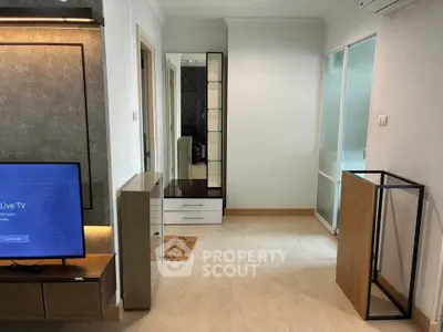 Modern apartment interior with sleek furniture and TV, showcasing a stylish and inviting living space.