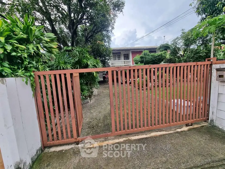 Charming suburban home with lush garden and secure gated entrance, perfect for family living.