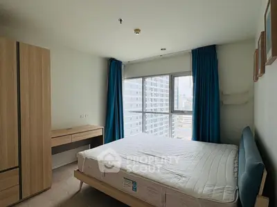 Spacious bedroom with city view, featuring modern furniture and large windows for natural light.