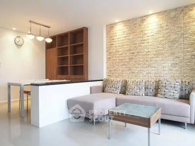 Modern living room with stylish furniture and brick accent wall