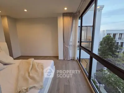 Modern bedroom with large windows and serene view