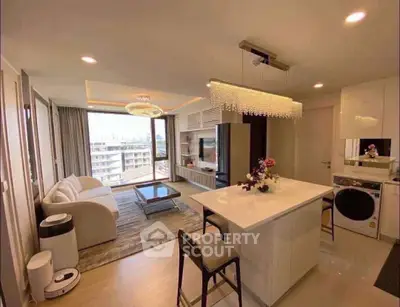 Modern open-plan living room with kitchen island and city view