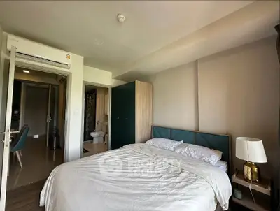 Cozy bedroom with modern decor and ensuite bathroom in a stylish apartment.