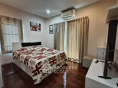 Cozy bedroom with stylish decor and natural light, featuring a comfortable bed and modern amenities.