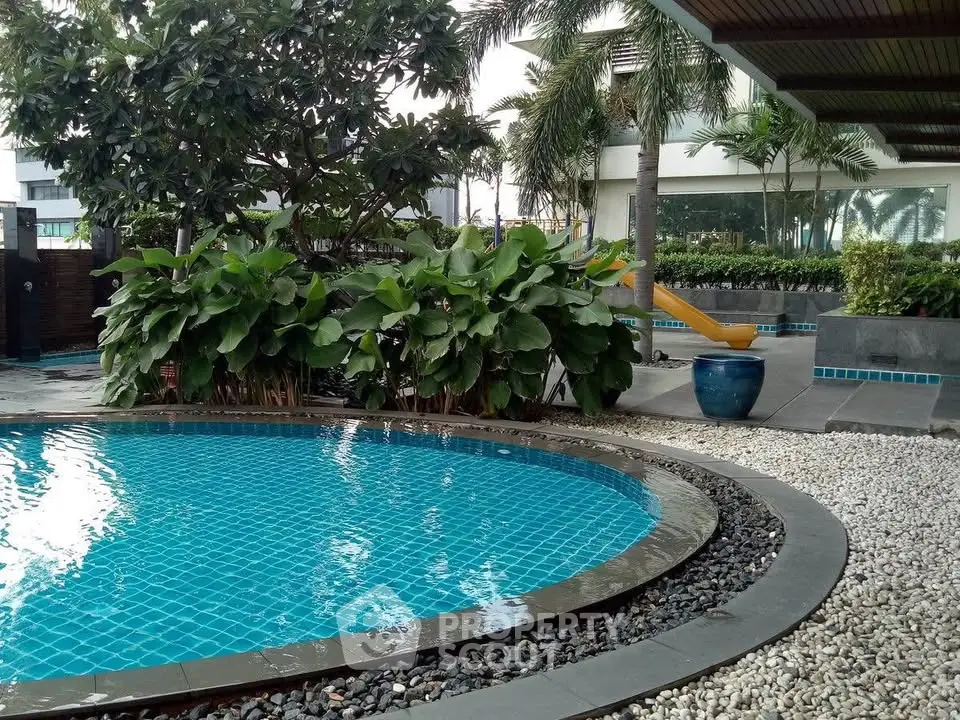Luxurious outdoor pool area with lush greenery and modern design, perfect for relaxation and leisure.