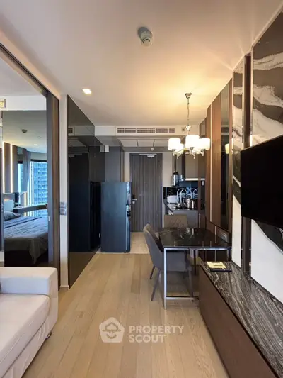 Modern apartment interior with open layout, featuring sleek kitchen and stylish living area.