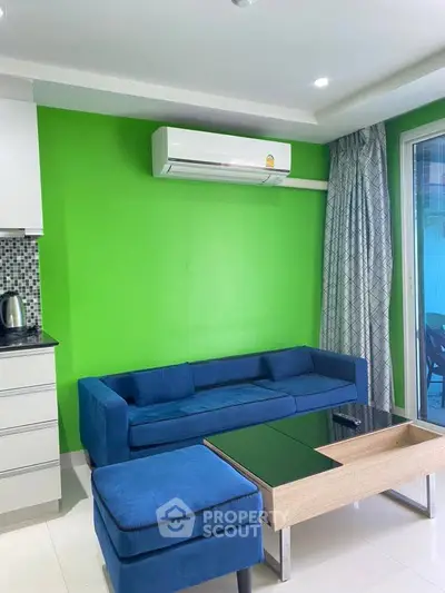 Modern living room with vibrant green wall and blue sofa