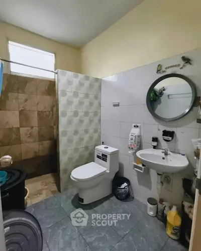 Spacious bathroom with modern fixtures and tiled shower area